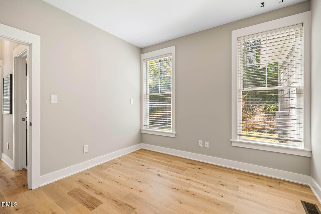 1905 Milan Street Durham, NC 27704 - Photo 23 of 42 a view of an empty room with wooden floor and a window