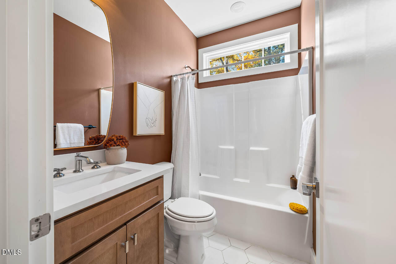 1905 Milan Street Durham, NC 27704 - Photo 24 of 42 a bathroom with a sink a toilet and shower