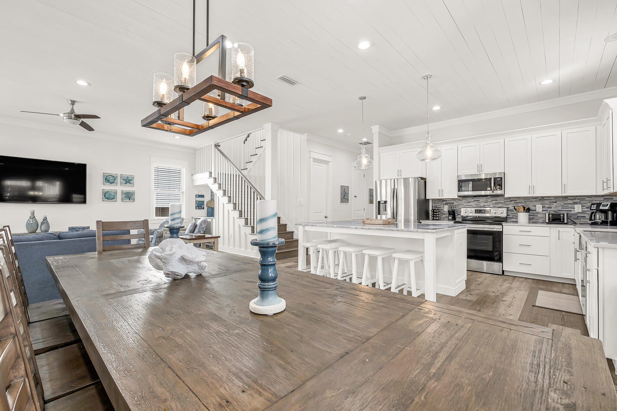 80 Sunfish Street Destin, FL 32541 - Photo 13 of 51 a kitchen with stainless steel appliances wooden floor dining table and chairs