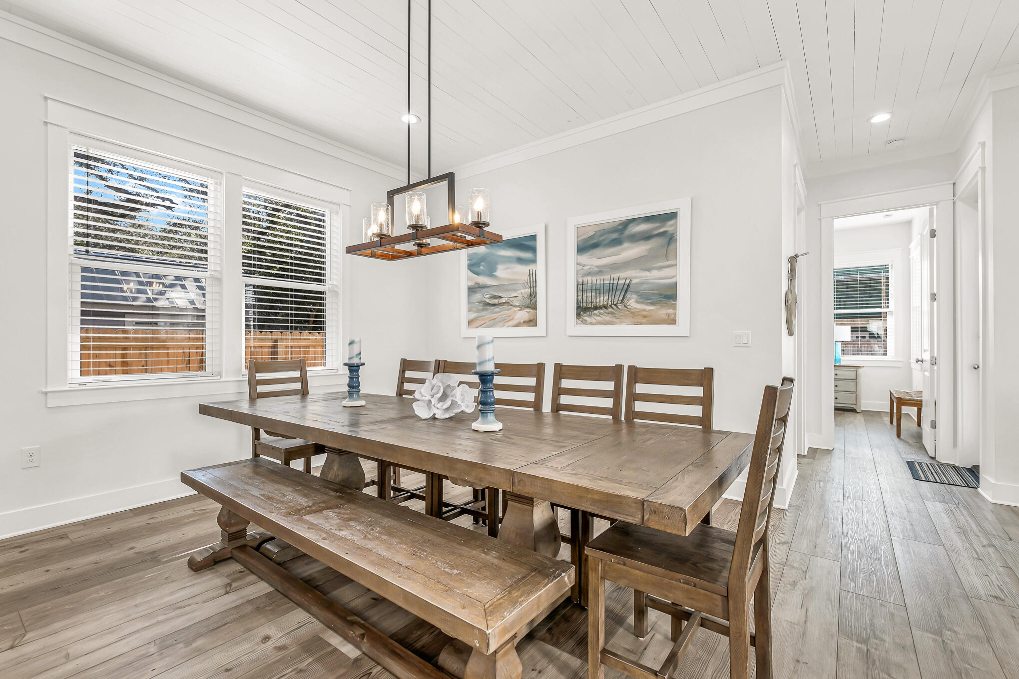 80 Sunfish Street Destin, FL 32541 - Photo 14 of 51 a dining room with wooden floor a chandelier a wooden table and chairs