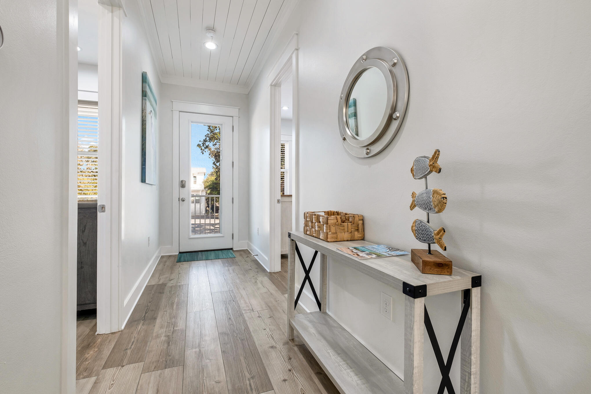80 Sunfish Street Destin, FL 32541 - Photo 19 of 51 a view of a hallway with wooden floor and a mirror