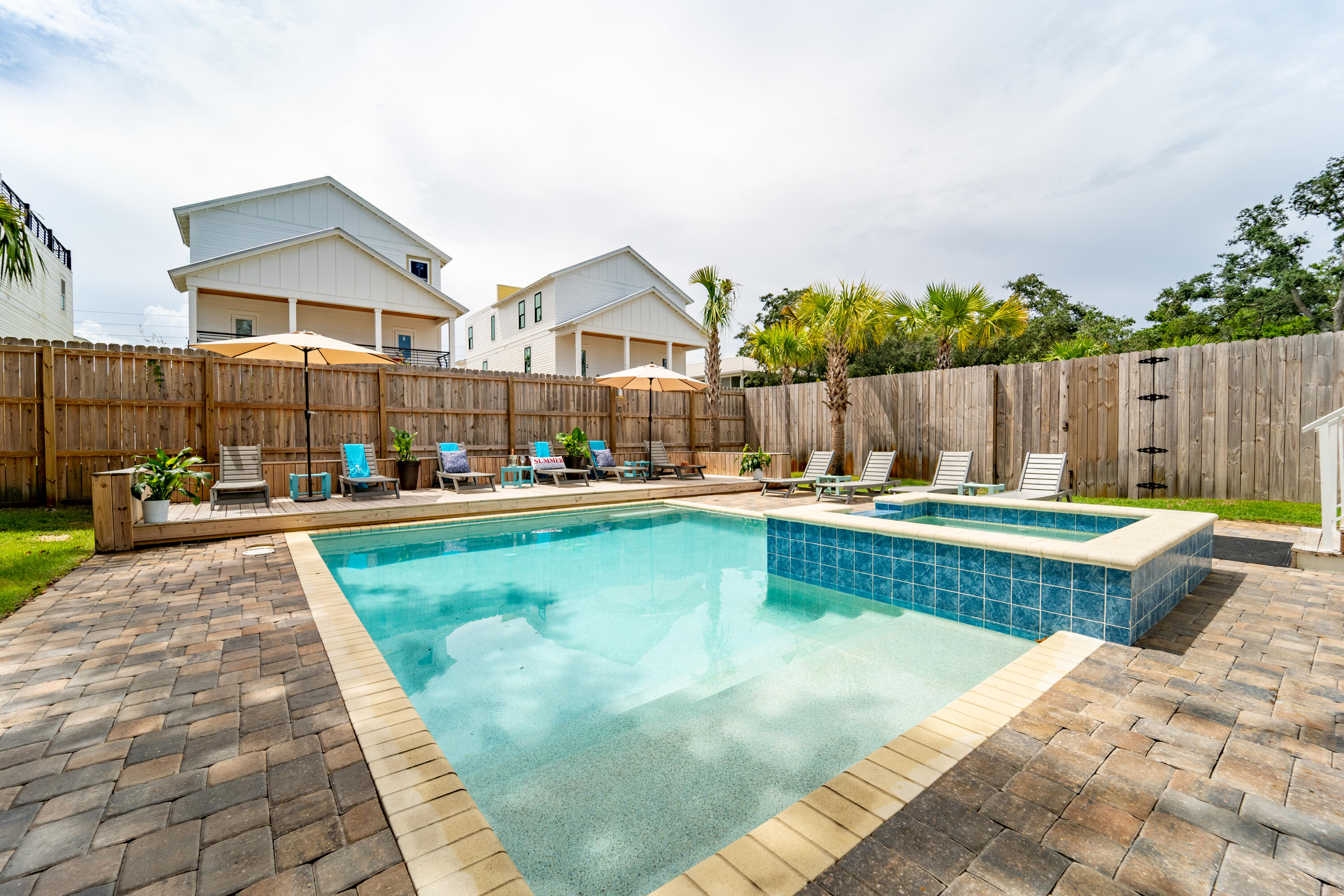 80 Sunfish Street Destin, FL 32541 - Photo 4 of 51 a view of swimming pool with seating space and wooden fence