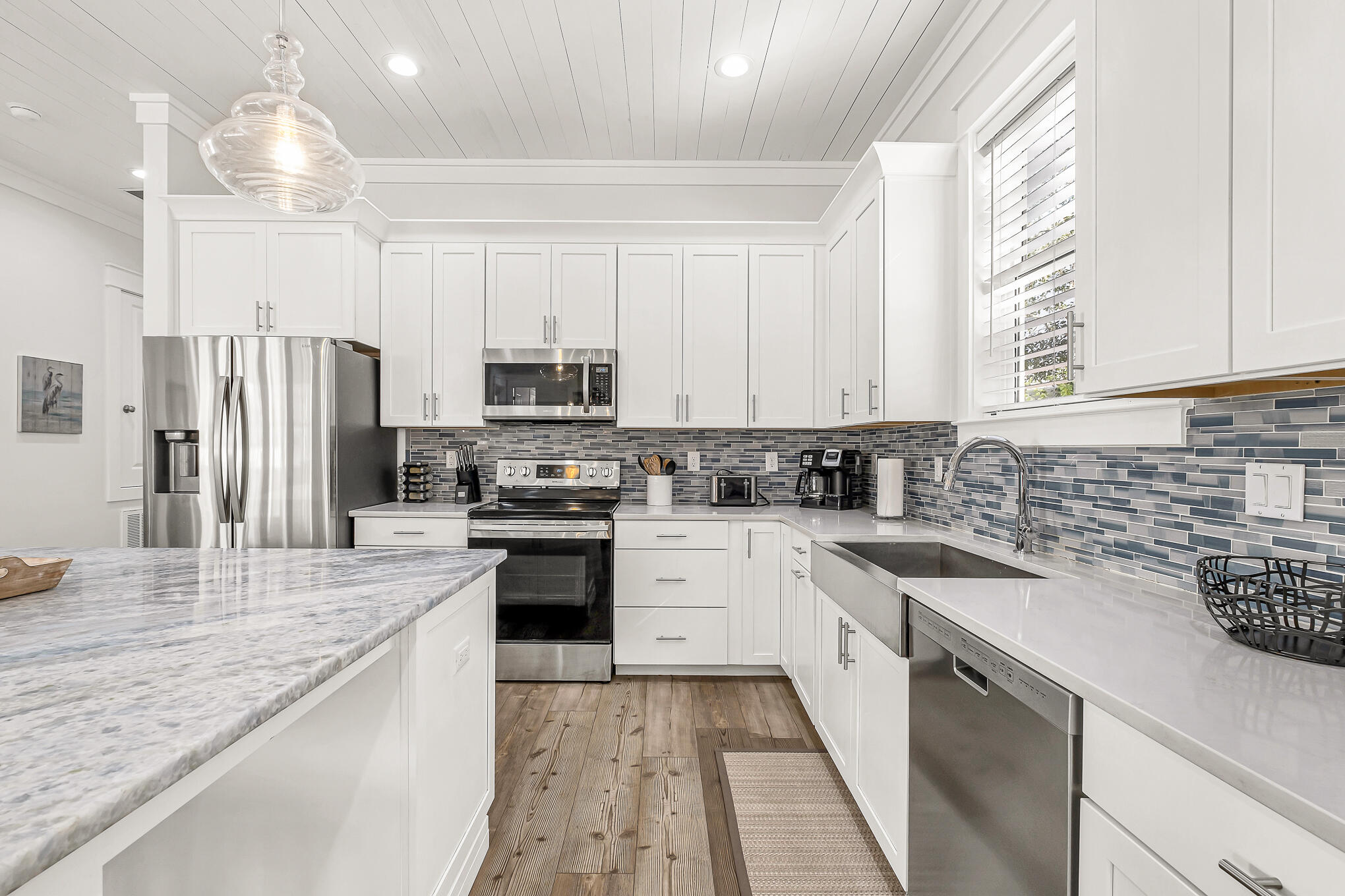 80 Sunfish Street Destin, FL 32541 - Photo 9 of 51 a kitchen with refrigerator a sink and white cabinets