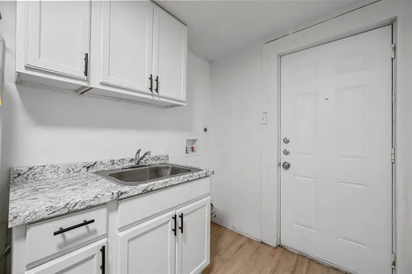 a sink and dishwasher with wooden floor