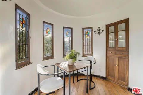 a view of a dining room with furniture window and wooden floor