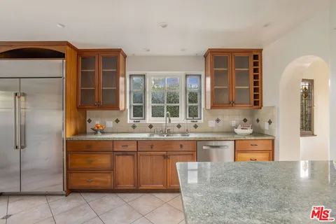 a kitchen with stainless steel appliances granite countertop a sink and cabinets