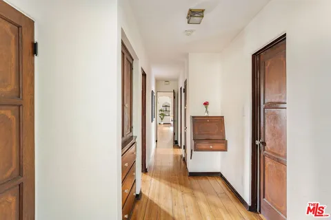 a view of a hallway view with wooden floor and staircase