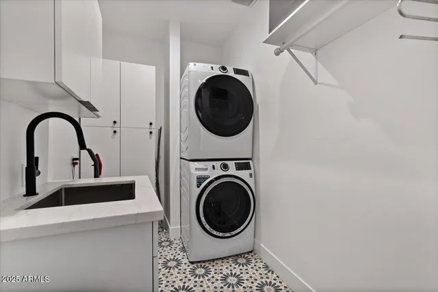 a close view of a utility room with dryer and washer