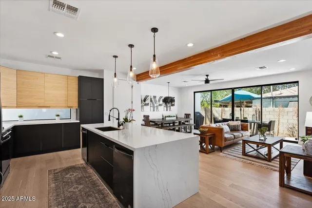 a kitchen with sink refrigerator and large window