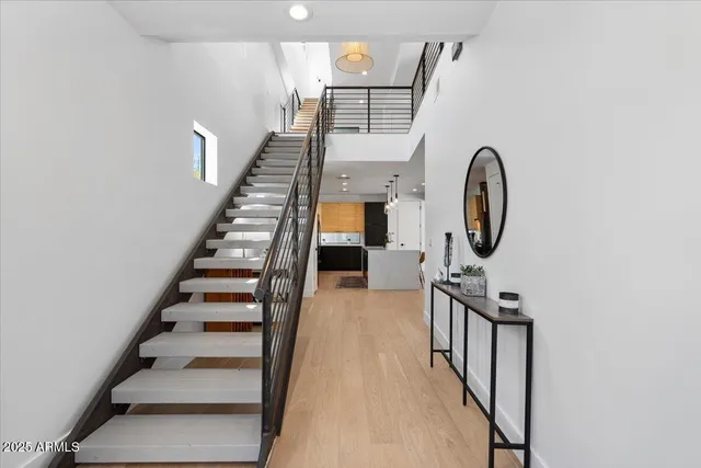 a view of entryway and hall with wooden floor