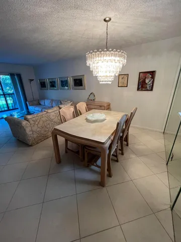a view of a dining room with furniture and window