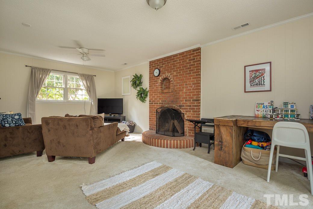 7625 Mine Valley Road Raleigh, NC 27615 - Photo 9 of 10 SPACIOUS lower level Den. There is plenty of room to arrange your furniture and be able to enjoy a cozy fire in the fireplace while watching your favorite movie on TV. This could also make an amazing Master Bedroom!
