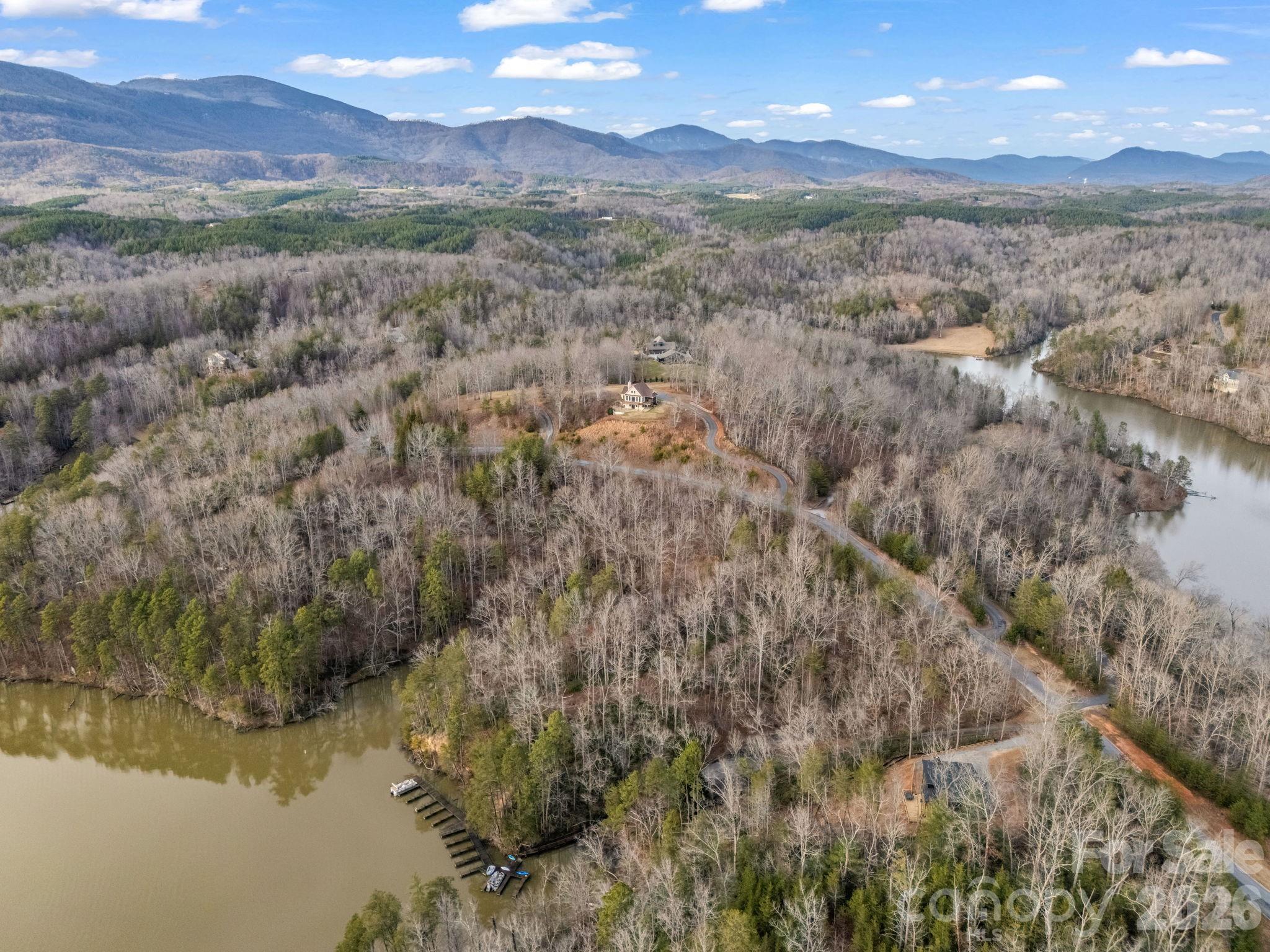 0 Jackson Cove Parkway West, Unit 2 Mill Spring, NC 28756 - Photo 42 of 43 a view of a lake with mountains in the background