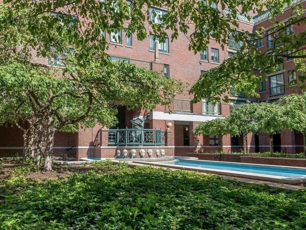 10 Rogers Street, Unit 203 Cambridge, MA 02142 - Photo 9 of 13 a front view of a house with a yard