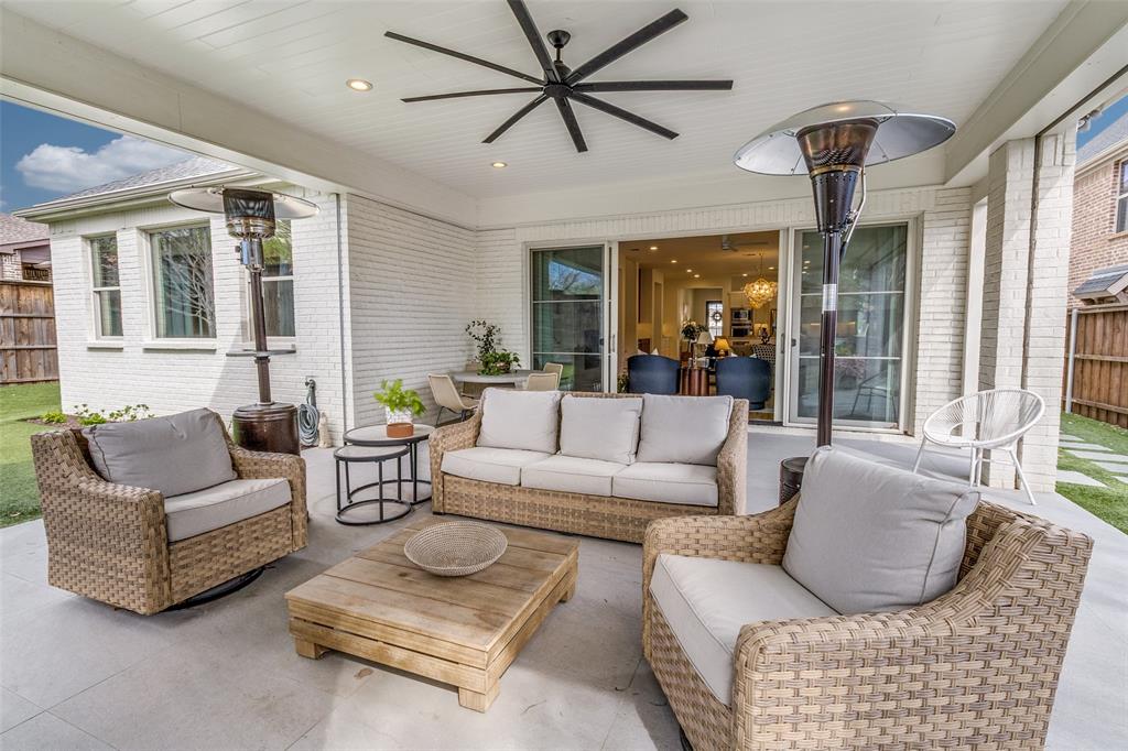 7533 Garonne Street Dallas, TX 75231 - Photo 27 of 32 a living room with furniture a large window and a chandelier
