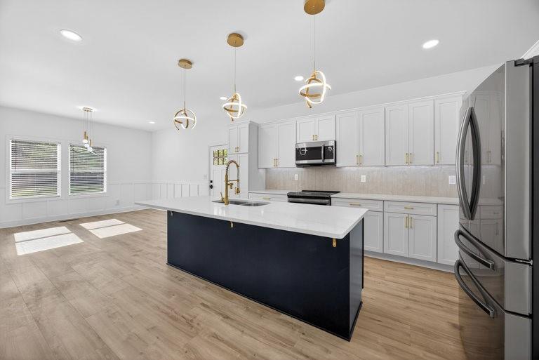 2177 Kipling Circle Southeast Atlanta, GA 30315 - Photo 11 of 27 a kitchen with kitchen island a sink stainless steel appliances and cabinets