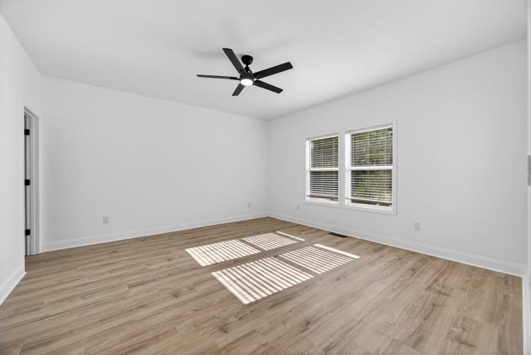 2177 Kipling Circle Southeast Atlanta, GA 30315 - Photo 12 of 27 a view of an empty room with a window and wooden floor