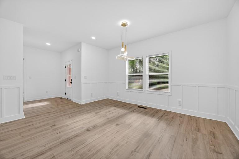 2177 Kipling Circle Southeast Atlanta, GA 30315 - Photo 13 of 27 an empty room with wooden floor and windows