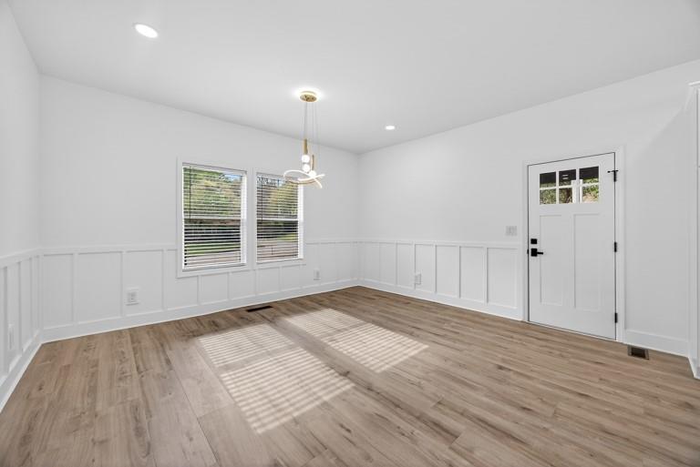2177 Kipling Circle Southeast Atlanta, GA 30315 - Photo 14 of 27 a view of an empty room with wooden floor and a window