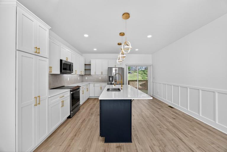 2177 Kipling Circle Southeast Atlanta, GA 30315 - Photo 9 of 27 a kitchen with stainless steel appliances kitchen island granite countertop a refrigerator a sink dishwasher a stove and a oven with wooden floor