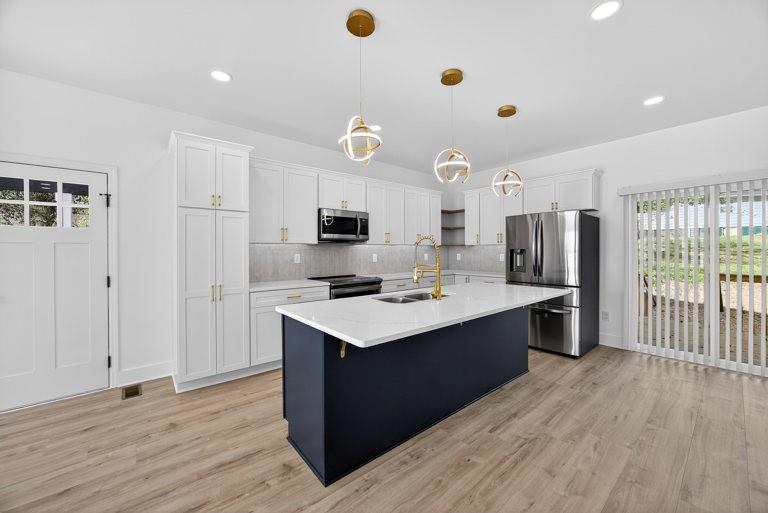 2177 Kipling Circle Southeast Atlanta, GA 30315 - Photo 10 of 27 a kitchen with stainless steel appliances a stove top oven and a refrigerator