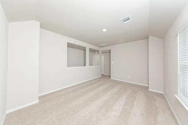 a view of an empty room with a window