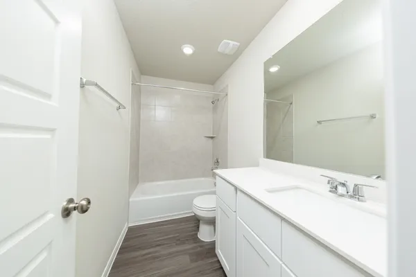 a bathroom with a sink a toilet tub and shower
