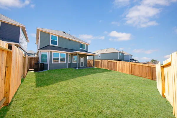 a view of an house with backyard and porch