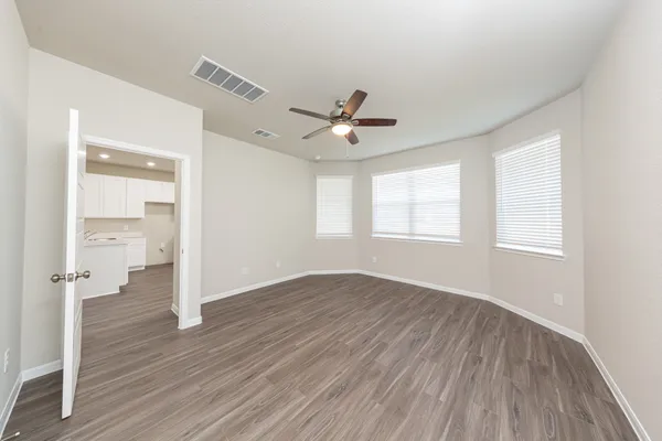 wooden floor in an empty room with a window