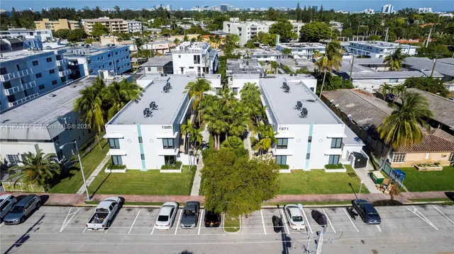an aerial view of a house with yard swimming pool and ocean view