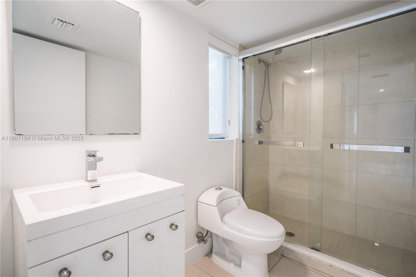 1985 Bay Drive, Unit 111 Miami Beach, FL 33141 - Photo 17 of 20 a bathroom with a sink toilet and shower