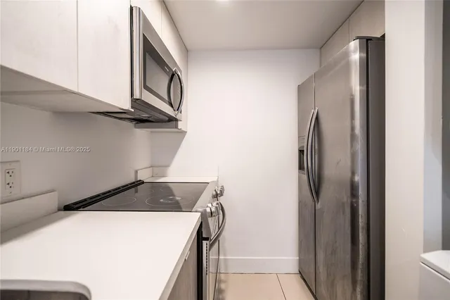 a kitchen with a refrigerator and a stove