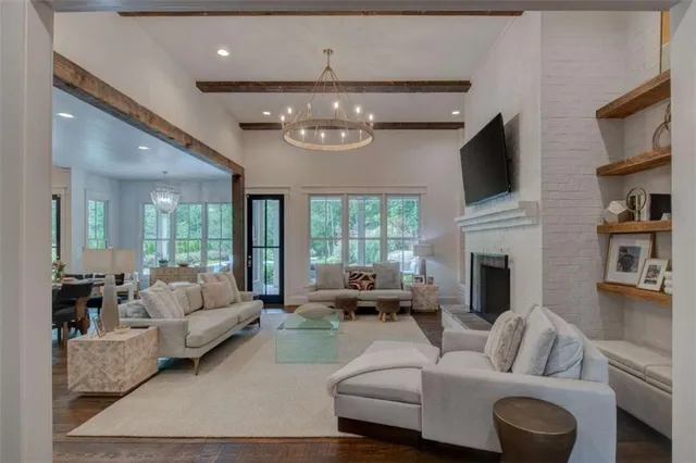 a living room with furniture and a chandelier