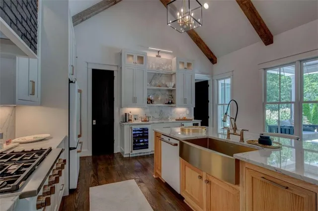 a bedroom with a bed a flat screen tv and a window