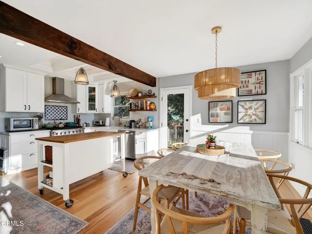 a kitchen with stainless steel appliances granite countertop a sink a stove and a refrigerator