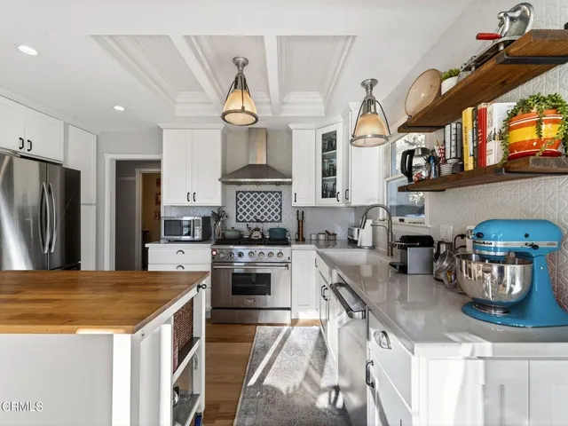 a kitchen with a stove a sink and a window
