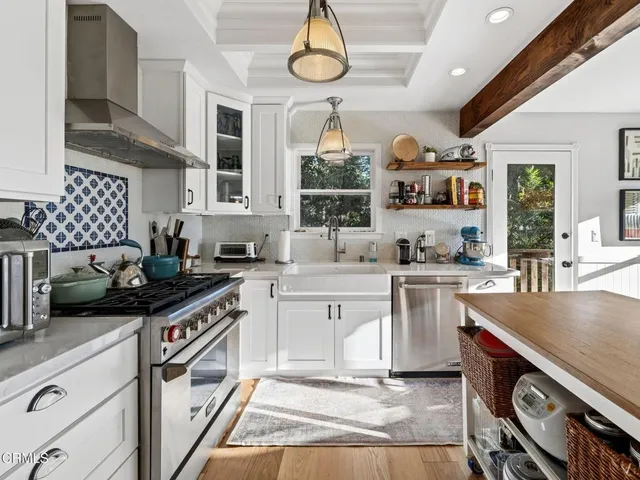 a dining room with a wooden table and chairs
