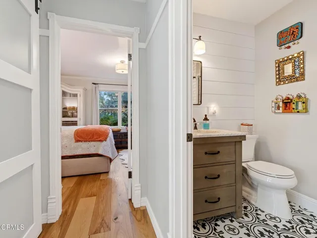 a bathroom with a granite countertop sink mirror vanity and toilet
