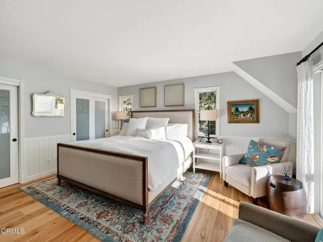 a spacious bathroom with a double vanity sink a mirror and a bathtub