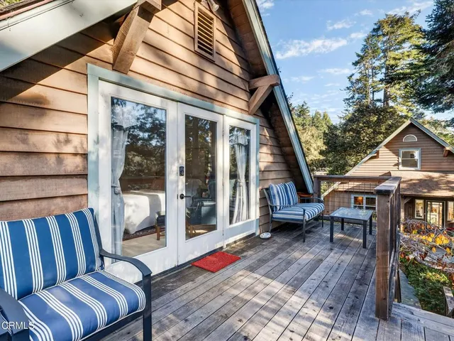 a bedroom with a bed and a large window with outer view