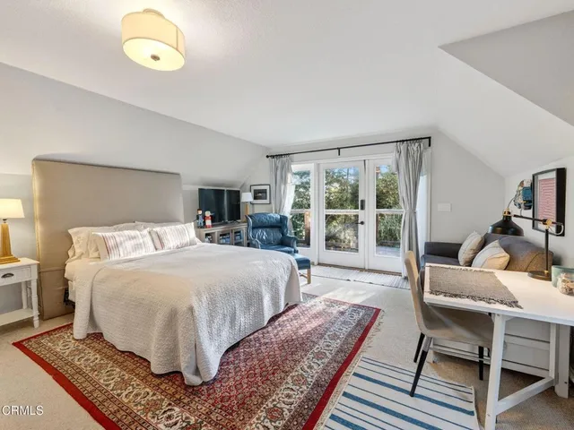 a bathroom with a tub a sink and mirror