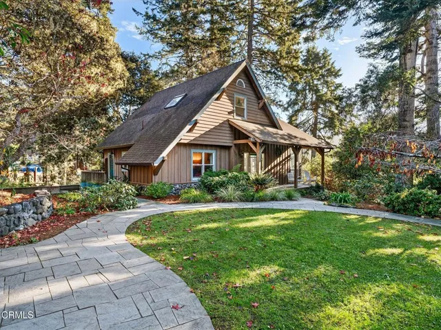 a front view of a house with a yard and porch