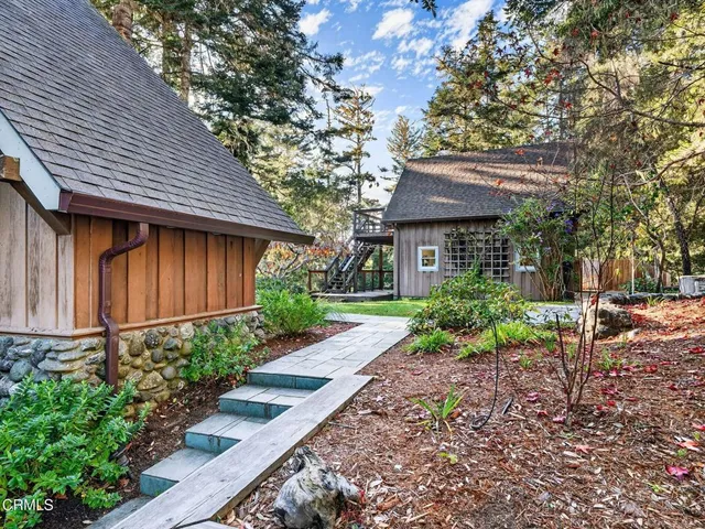 a view of a patio with table and chairs and potted plants