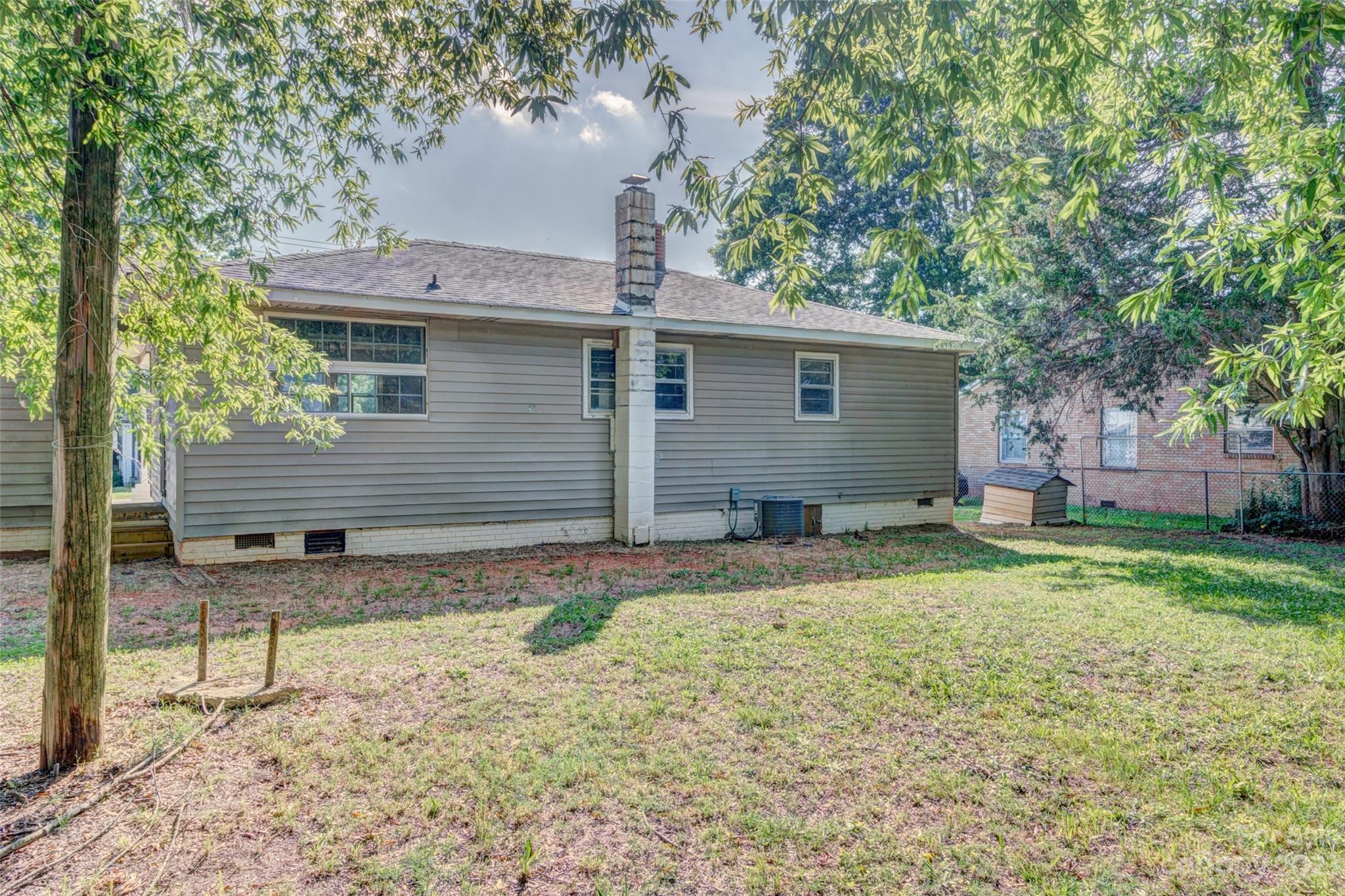 402 Delview Road Cherryville, NC 28021 - Photo 11 of 11 a backyard of a house with a garden and barbeque oven