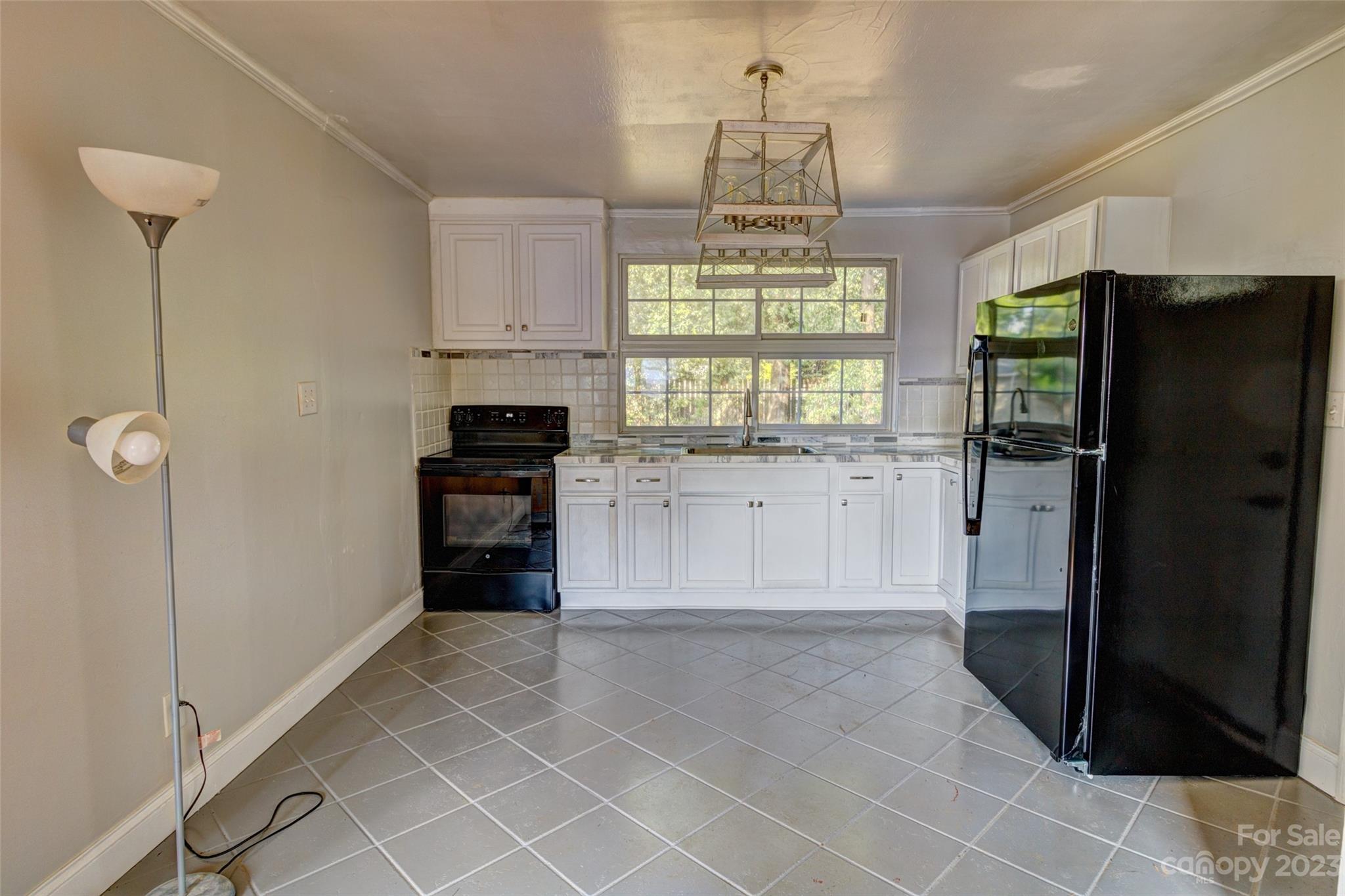 402 Delview Road Cherryville, NC 28021 - Photo 4 of 11 a kitchen with granite countertop a refrigerator and a stove top oven