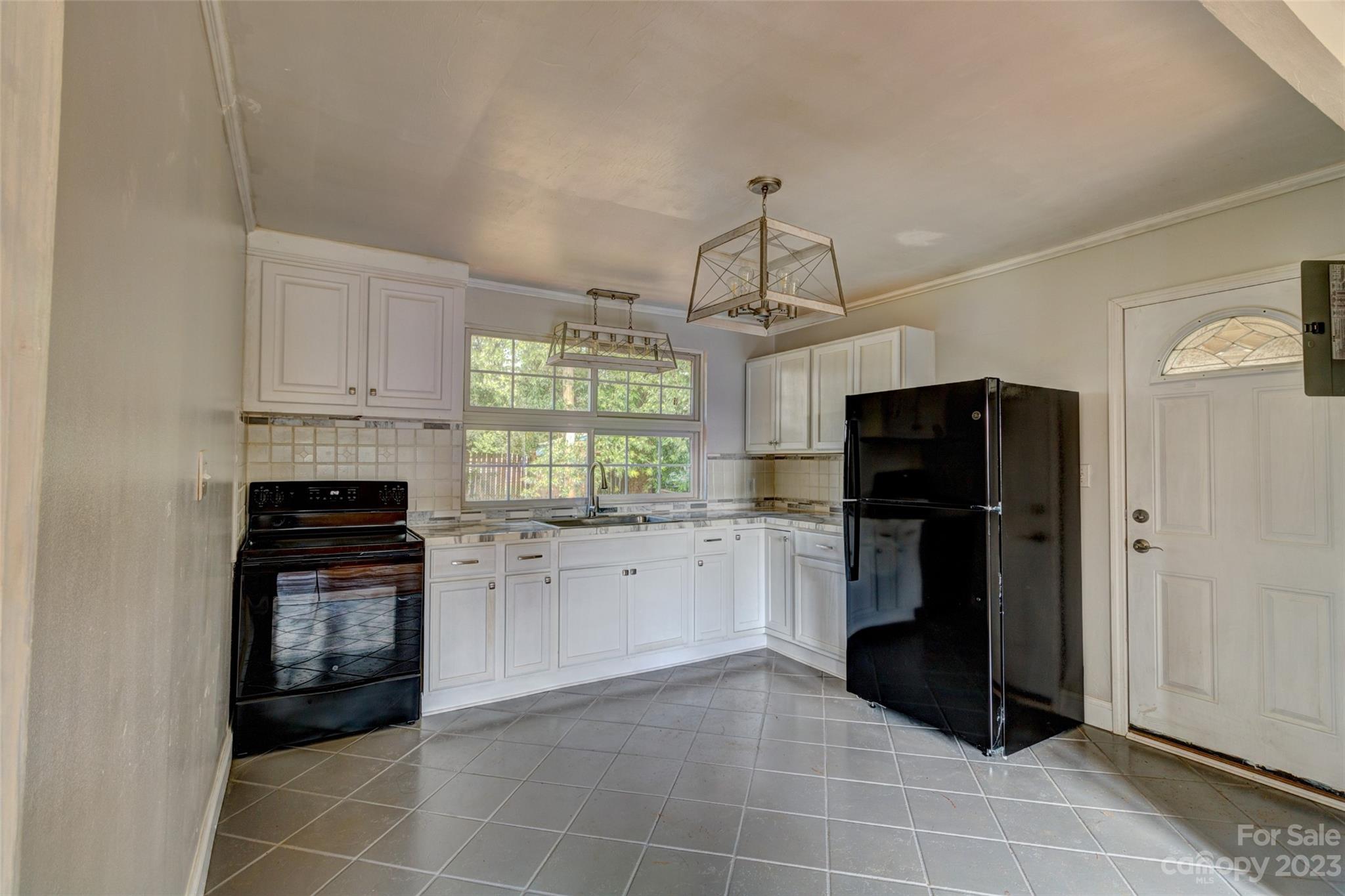 402 Delview Road Cherryville, NC 28021 - Photo 5 of 11 a kitchen with granite countertop a refrigerator stove and microwave