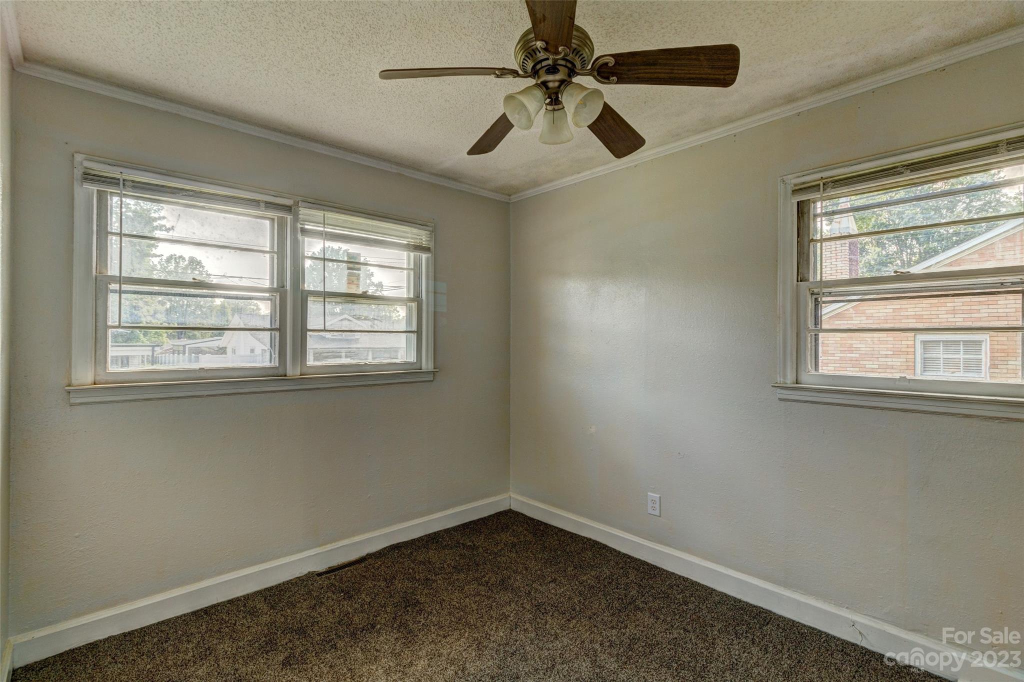 402 Delview Road Cherryville, NC 28021 - Photo 6 of 11 an empty room with windows and fan
