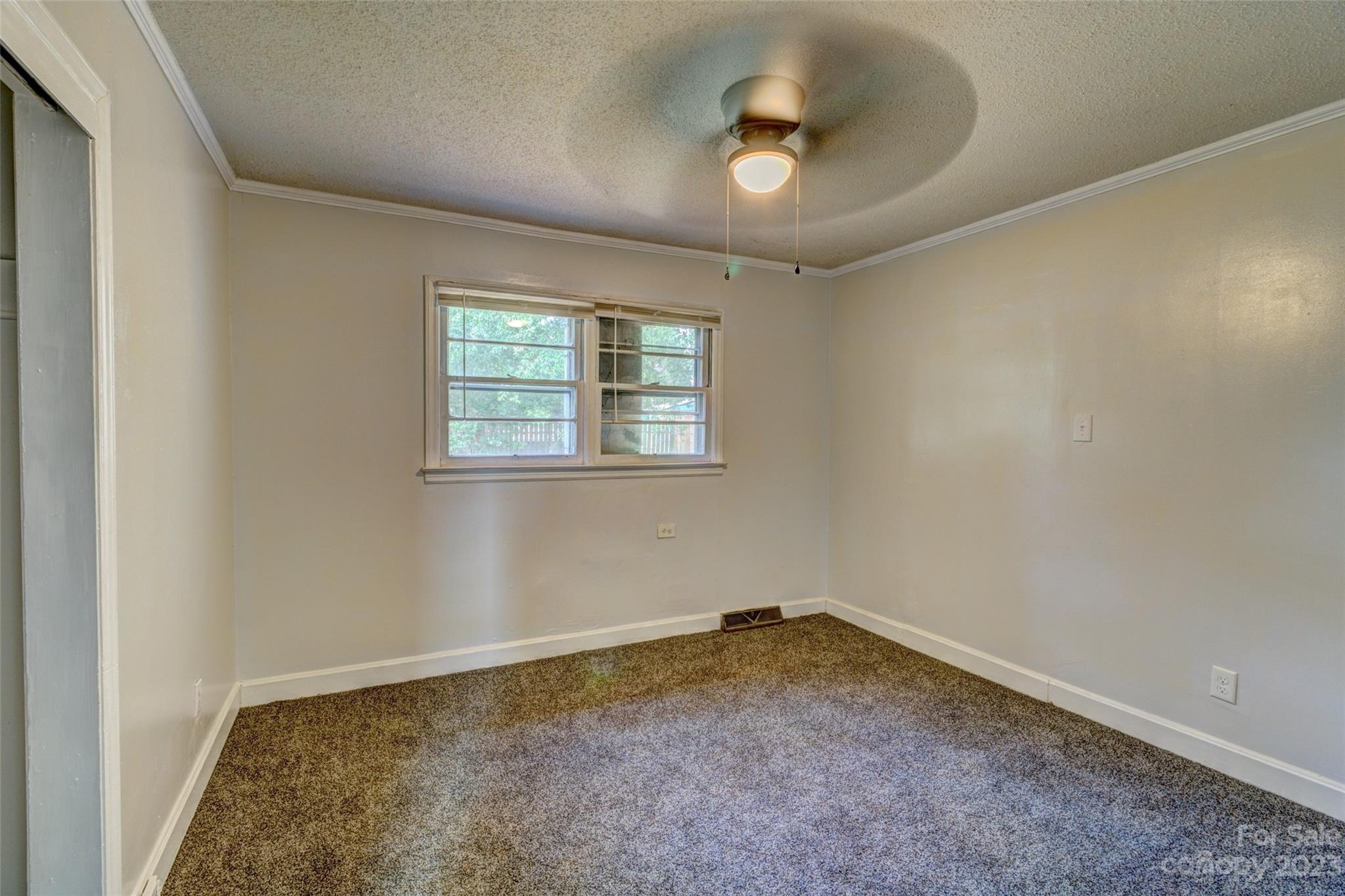 402 Delview Road Cherryville, NC 28021 - Photo 8 of 11 an empty room with a stove and a window