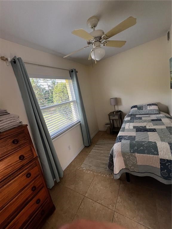 11195 Roseland Road, Unit 4 Sebastian, FL 32958 - Photo 8 of 10 a bed room with a bed and a window