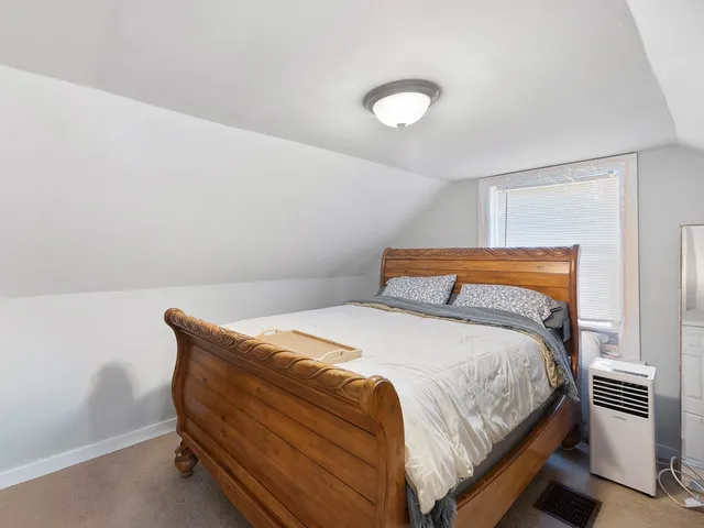 a bedroom with a bed and a lamp